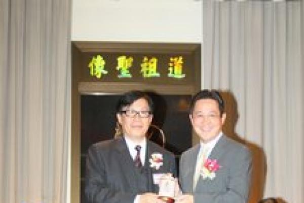 校長梁贊榮博士致送紀念品予教育局副局長陳維安太平紳士。